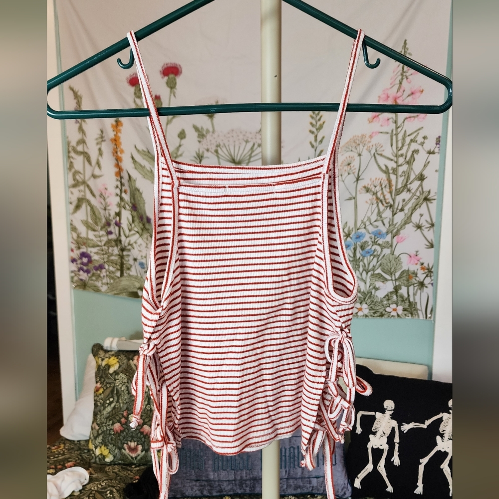 Red and white crop top with side ties and open sides.
